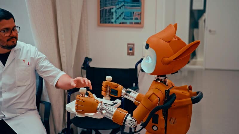 Image showing a technician interacting with cute looking robot.